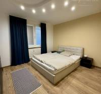 A bedroom with stylish lighting and a bed in a 4-room apartment.