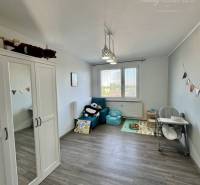 Children's room with toys, wardrobe, and dining chair in a 4-room apartment.