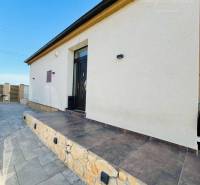 A family house with an elegant stone staircase, a minimalist facade, and modern exterior lights.