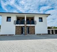 The exterior of a family house in the town of Veľký Meder with a paved access area.