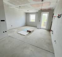 Bare walls and a floor with a wooden decor in a 3-room apartment.