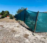 Land in Veľký Meder suitable for living, fenced, with natural vegetation.