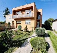 A family house in Okoč with a landscaped garden and a balcony in a pleasant environment.