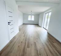 A family house with white walls and a floor with a wood decor.