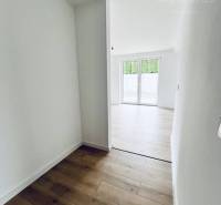 Interior of a family house with a wooden decor floor and white walls.