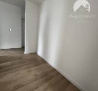 Interior of a family house with a wooden decor floor and white walls.
