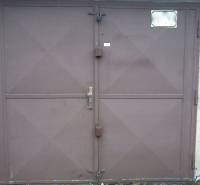 Brown metal garage doors on Čmelíkova Street in Bratislava - Ružinov.