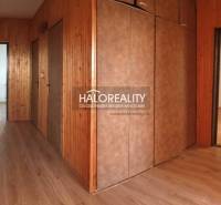 Hallway of a 4-room apartment with wooden paneling and flooring with a wood decor.