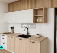 A kitchen in a 4-room apartment with white cabinets and a wood-patterned floor.