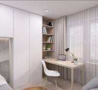 A workspace in a family house with a desk, chair, and books on shelves.