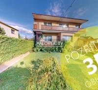 A family house in Krasňany with a front garden and a green hedge.