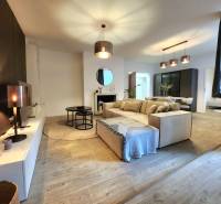 Interior of a 2-room apartment with a wooden decor floor and stylish lighting.