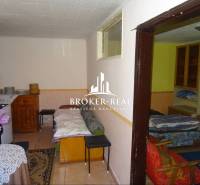 Interior of a family house with furniture, a sofa, and decorations on the table.