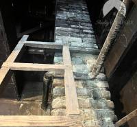 Attic in a family house with a brick wall and beams, Reality Komplex.