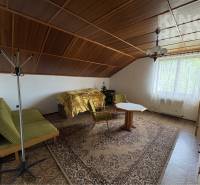 Attic room in a family house with a wooden decor floor and furniture.