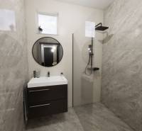 A bathroom in a family house with a modern shower and a round mirror.