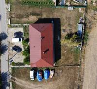 Aerial view of a family house in Zemianska Olča with a shelter and parking lot.