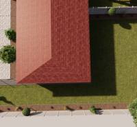 A family house in Zemianska Olča with a red roof and a landscaped garden.