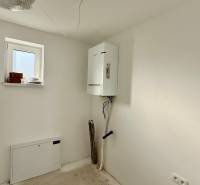 White room with a gas boiler in a family house.