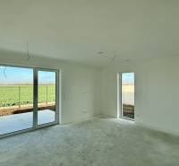 A room in a family house with access to a terrace and a view of the field.