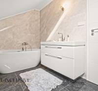 A bathroom in a family house with a freestanding bathtub and a modern sink.