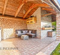 Exterior of a family house in Dobrohošť with a seating area and brick walls.