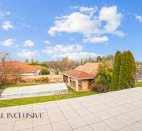 A view of the garden with a covered pool and a gazebo in a family house in Dobrohošť.