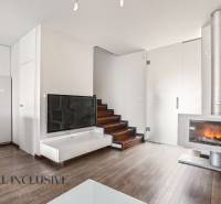 Interior of a family house with a fireplace, staircase, and floor with wood decor.