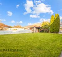 The garden of a family house in Dobrohošť with a lawn, a small pool, and a terrace.