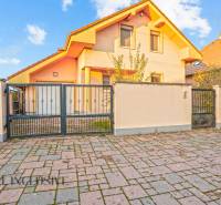 A family house in Dobrohošť with a terracotta roof and a landscaped front garden.