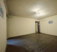 A room with a wooden decor floor and white walls in a family house.