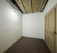 A simple room in a family house with white walls and brown doors.