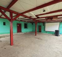 A spacious terrace of a family house in Kolárovice with a covered roof and a projection screen.
