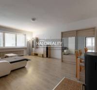 Living room in a family house with a sofa, table, and wooden decor flooring.
