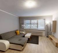 Living room with wood-patterned flooring, gray sofa, and large window in a family house.