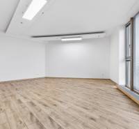 Spacious room with wooden decor flooring and a large window in a 3-room apartment.