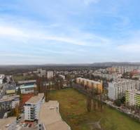 The view of Petržalka shows a housing estate with apartment buildings and open space.