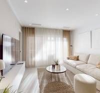 Living room with a comfortable sofa, television, and elegant decor in the Holiday Apartment.