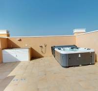 Rooftop terrace of a holiday apartment in El Raso with a hot tub and sink.