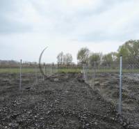 A fenced plot of land on Nad potokom Street in Zohor for residential purposes.