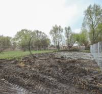 Plots - living near Zohor on Nad potokom street, fenced plot with trees and grass.