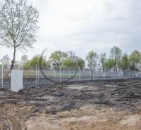 A residential plot on Nad potokom street in Zohor, bordered by a fence with an electrical box.