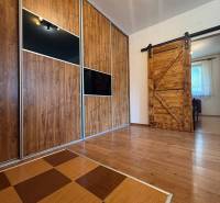 Two-tone floor with wood decor and sliding doors in a 3-room apartment.