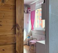 Children's room with light furniture and a wooden decor floor in a 3-room apartment.
