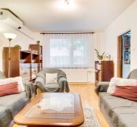 Living room in a 3-room apartment with comfortable sofas and a floor with a wooden decor.