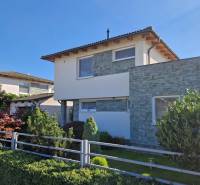 A family house on Jachtárska Street in Piešťany, surrounded by greenery and stone.