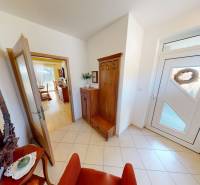 Entrance hall of a family house with furniture and glass doors, floor with wood decor.