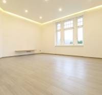 A bright spacious room in a 3-room apartment with a wooden decor floor.