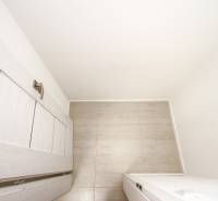 A bright space with sliding doors and a wood-patterned floor in a 3-room apartment.