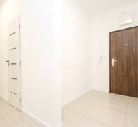 Entrance hallway in a 3-room apartment with tiles and white walls.